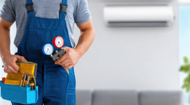 Hvac technician with tools repairing air conditioner