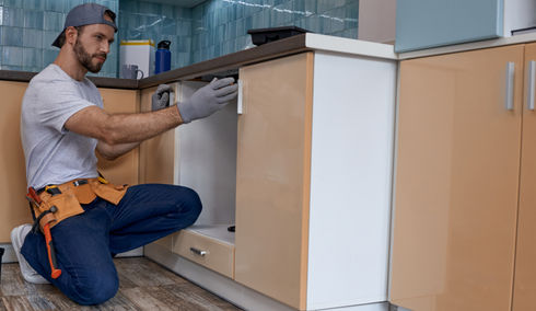 Young caucasian worker measuring drawer kitchen furniture